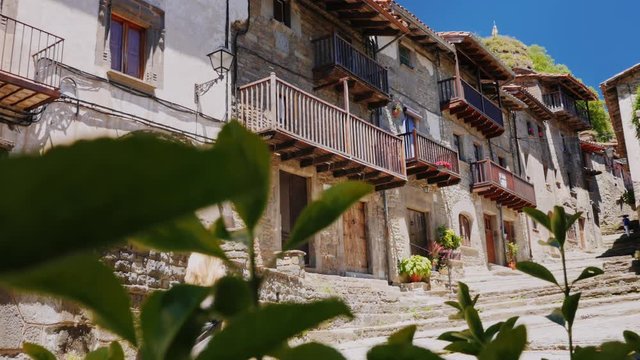 Tours woman walks in the Catalan town of Rupit. The famous landmark of Catalonia and Spain - the city of witches