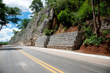 Stone with wire mesh for protection rock falling from mountain