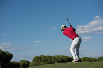 golf player hitting long shot