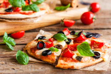 pizza with tomatoes, mozzarella and basil