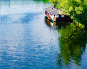 Wooden house on the river. Summer.