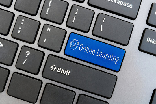 Computer keyboard with computer cursor icon and word Online Learning on blue enter button. Online education concept.