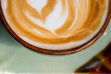 Close up of a cup of coffee with latte art.