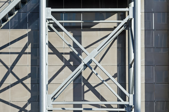 Building's Facade. Ladder Element. X-Shaped Metal Weldments To Background Composite Aluminum Panels. Backup.