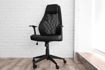 New office chair on the brick wall background