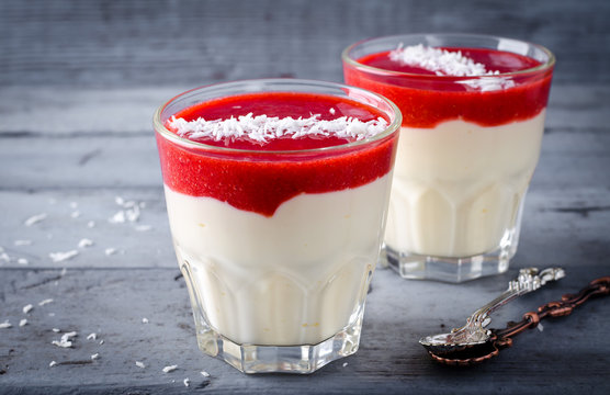 Creamy Dessert With Strawberry Sauce And Coconut Flakes In Glasses