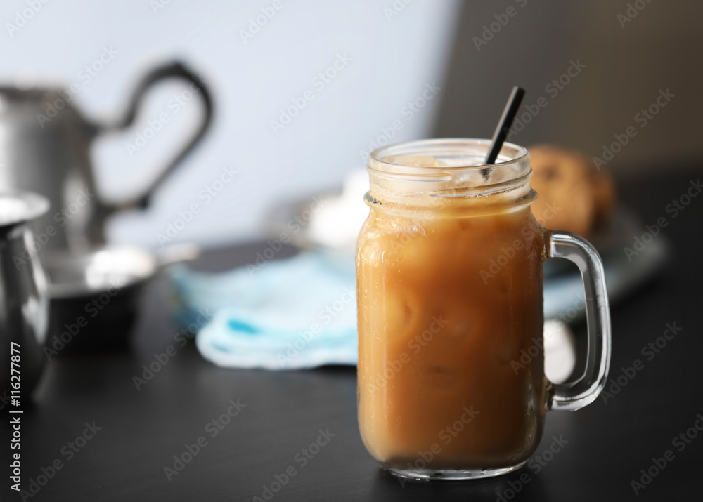 Poster iced coffee in glass jar on black table