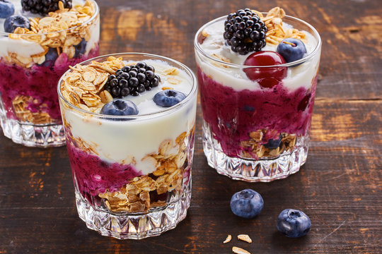Tree yogurt desserts with berries and muesli.