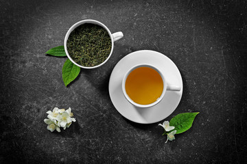Obraz na płótnie Canvas Cup of tea with jasmine flowers on color background