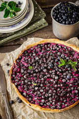 Homemade pie with bilberry  on dark wooden table