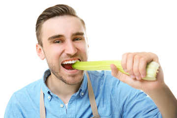 Handsome man eating celery, isolated on white