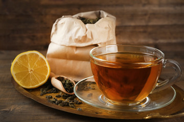 Cup of black tea with lemon on tray