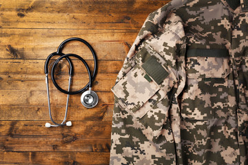 Stethoscope and military uniform on wooden background