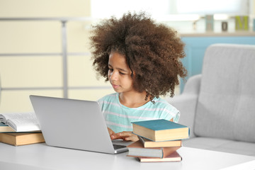 Fototapeta na wymiar Cute African girl doing homework