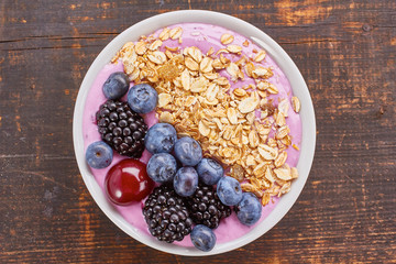 Dish of yogurt smoothie, fresh berries and muesli