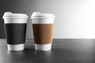 Coffee-to-go. Paper cups of coffee on the table