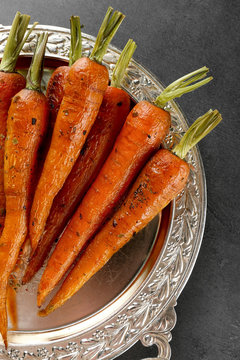 Tasty grilled carrots on silver tray