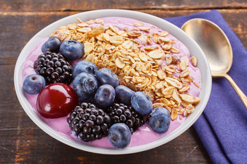 Dish of yogurt smoothie, fresh berries and muesli