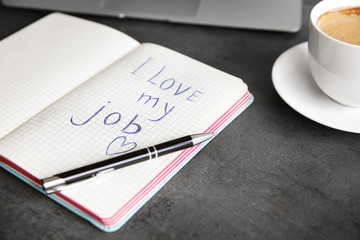 I love my job concept. Open notebook on office table