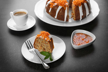 Delicious slice of carrot cake with mint on plate