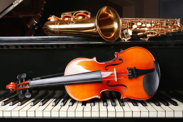 Violin with saxophone and piano, closeup