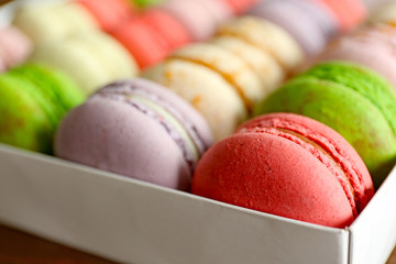 Different colorful macaroons in box, close up