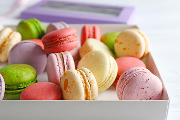 Different colorful macaroons in box, close up
