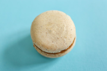 Tasty macaroon on light blue background