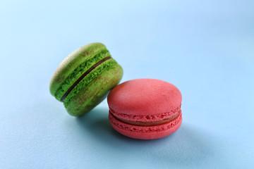 Tasty macaroons on light blue background