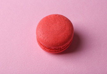 Red tasty macaroon on pink background