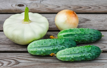 Squash, onions and cucumbers on table