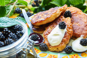 Homemade pikelets with forest blackberries and sweet cream