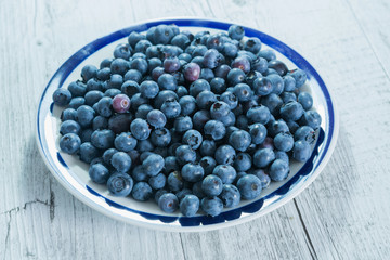 Blueberry antioxidant organic superfood in a bowl on table, concept for healthy eating and nutrition