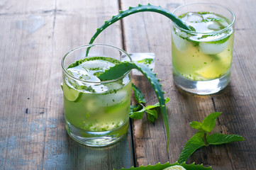 Aloe vera and lime cocktail with mint and ice cubes