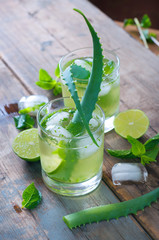 Aloe vera and lime cocktail with mint and ice cubes