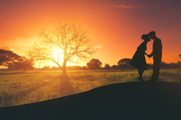 Fototapeta premium Couple kissing at sunset.