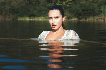 Fototapeta premium Woman emerged from the water.