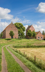 Fototapeta na wymiar Medieval church on a mound in Groningen village Ezinge