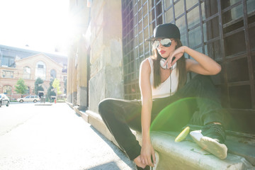 Rapper girl with headphones in a european city