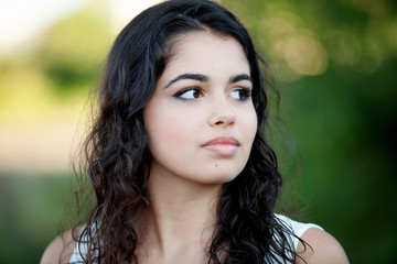 Beautiful brunette girl relaxing in the park