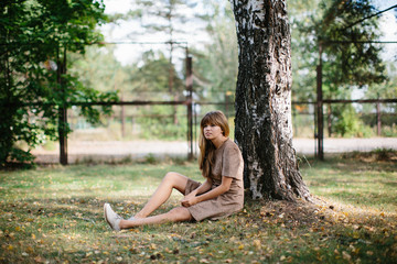 young beautiful girl posing in the park