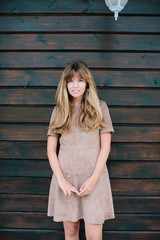 Fototapeta premium girl posing on a background of wooden wall
