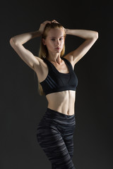 Fototapeta premium Beautiful sexy blonde woman perfect athletic slim figure engaged in yoga, exercise or fitness, lead healthy lifestyle, eats right, dressed in comfortable casual clothes sport pilates diet body shape