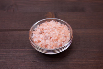 Obraz na płótnie Canvas Himalayan pink salt to bowl on a wooden table