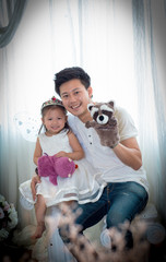 The family, child and home concept - smiling parents and little