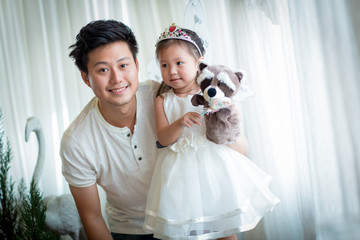family, child and home concept - smiling parents and little girl