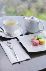 Tea and desserts on black table in a cafe