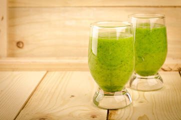 Healthy green smoothie with spinach, kiwi, apples, salad and mint in glass