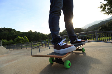 young skateboarder legs skateboarding at skate park
