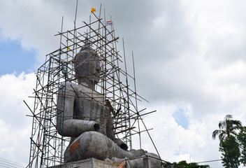 Buddha statue with construction in Thai temple